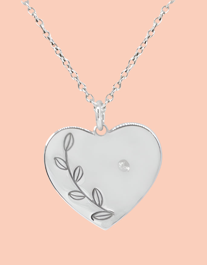Sterling silver children's heart pendant with floral vine design and small gemstone, perfect for flower girls or First Communion gifts.