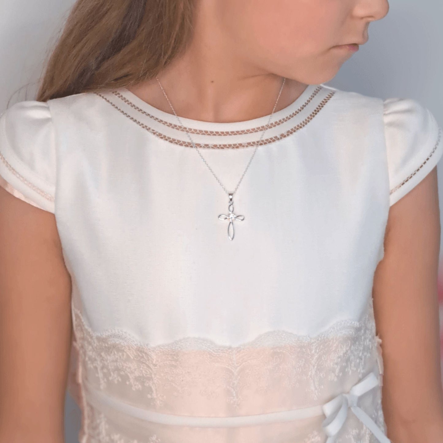 Girl wearing Silver Communion Cross necklace